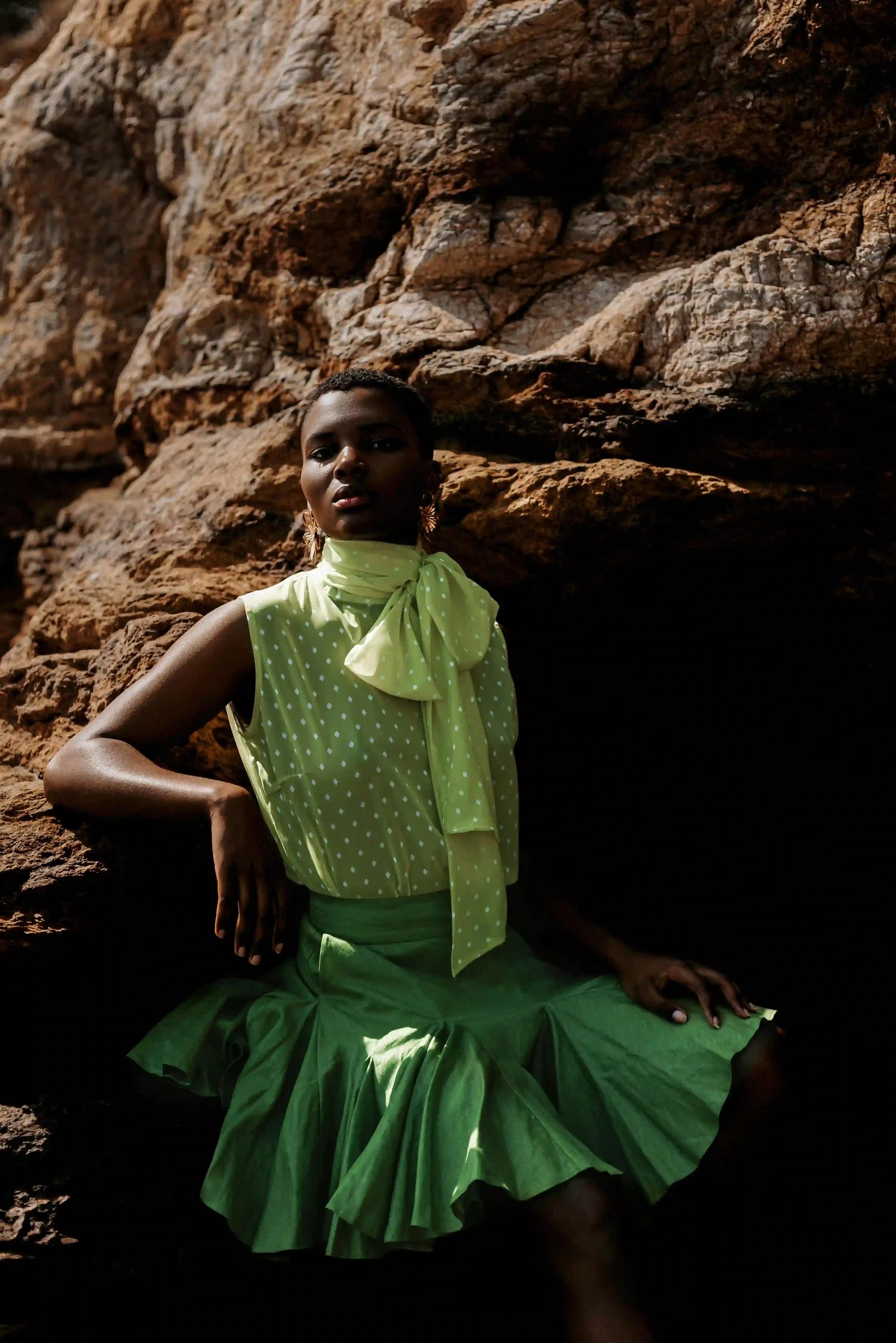 Outdoor photo of a model wearing a vintage green dress