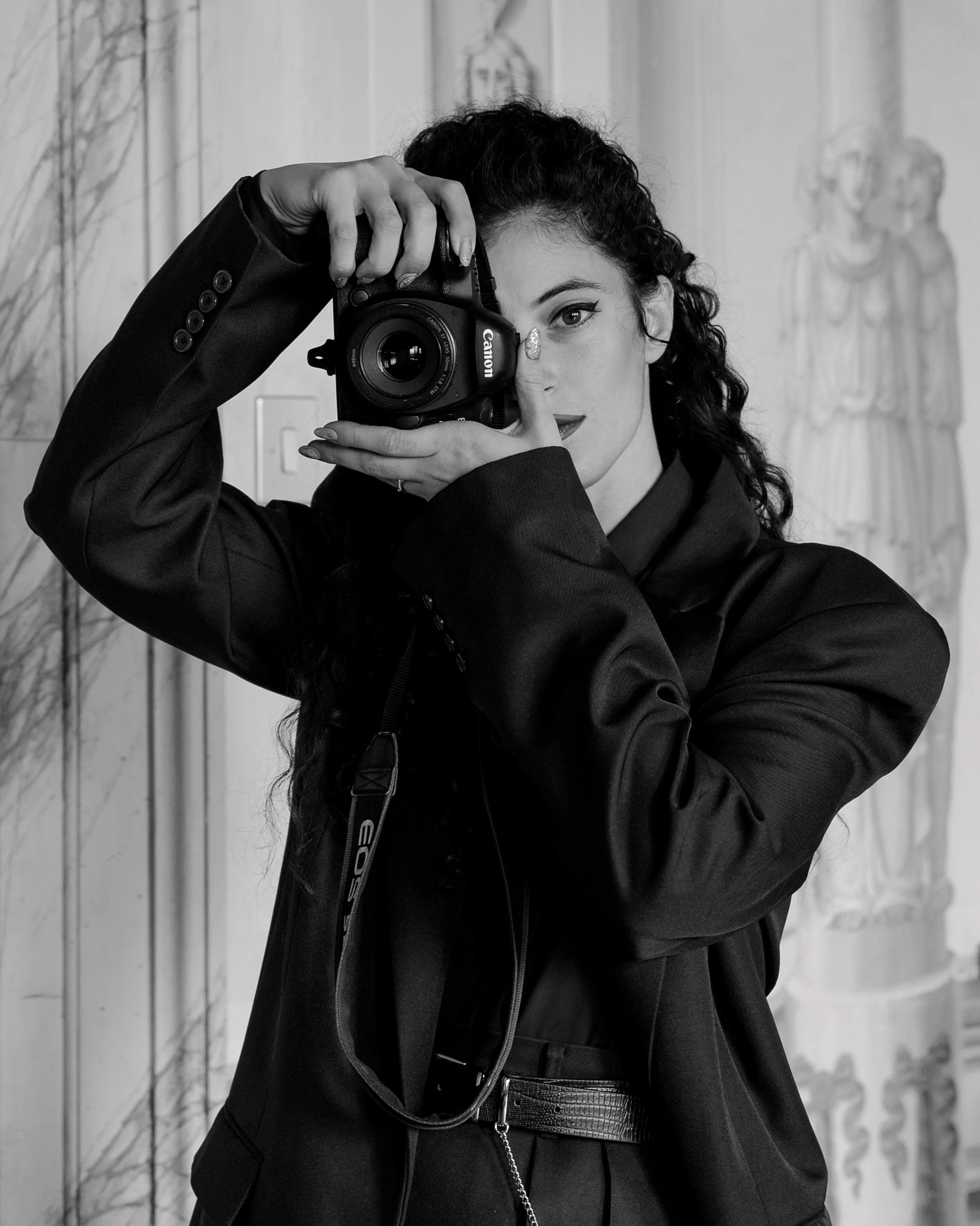 Virna, the photographer who holds the camera in one hand and takes pictures,